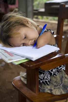Girl writing at school, Cambodia